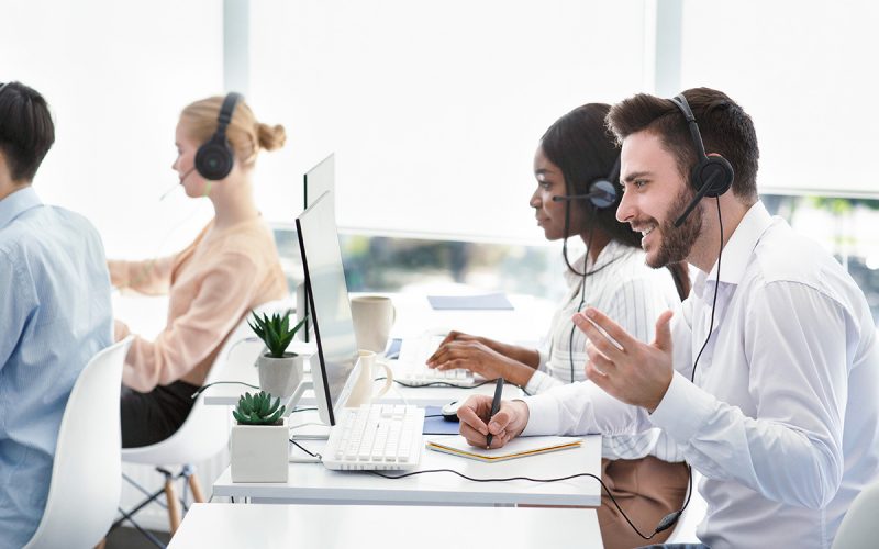 Customer Service representatives assisting clients via Voice Over IP headsets.